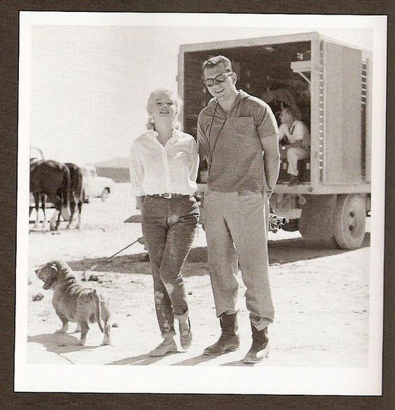 M. Monroe with a guy and its Basset Hound dog