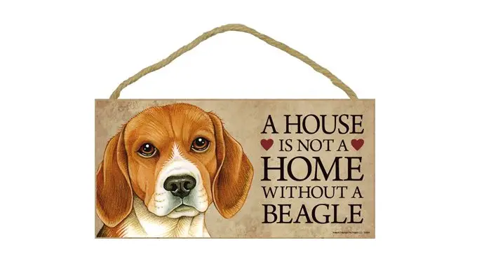 a wooden door sign with the face of a Beagle and saying - A house is not a home without a beagle