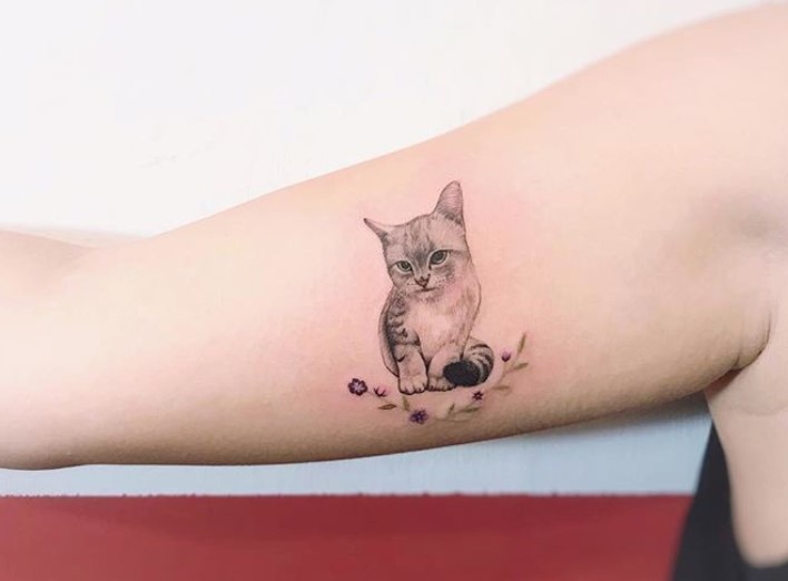 black and gray minimalist cat tattoo on the biceps