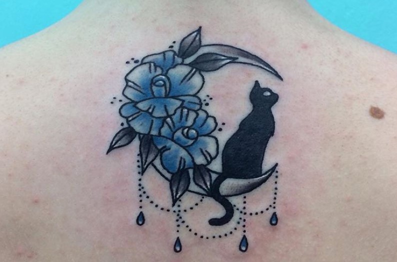 black cat sitting on a crescent moon with blue flowers