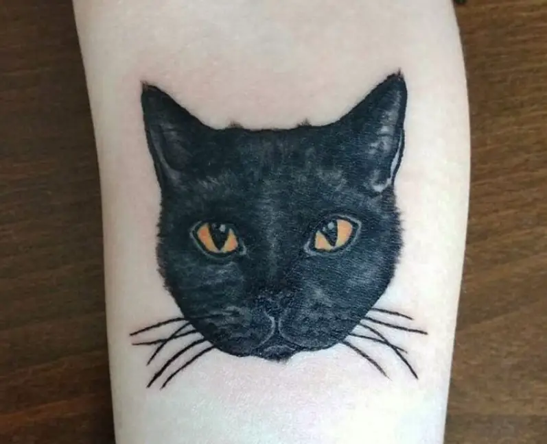 face of black cat tattoo on wrist