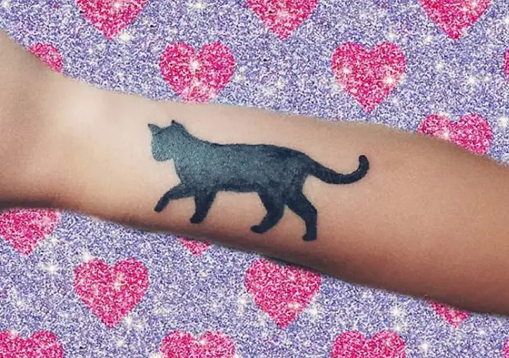 walking black cat tattoo on wrist