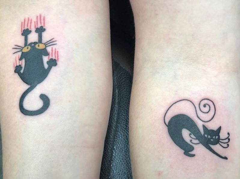 couple black cat scratching and stretching tattoo on arms