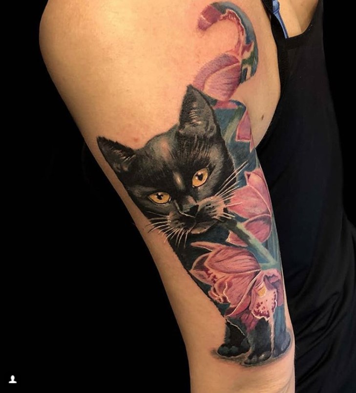 black cat with red flowers tattoo on arms