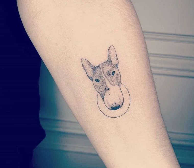 minimalist black and gray face of a Bull Terrier tattoo on the forearm.