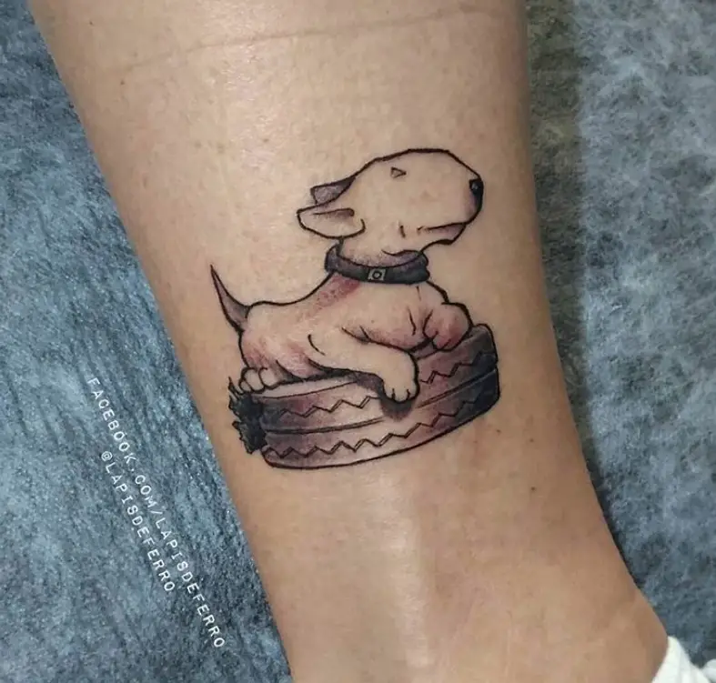 Bull Terrier lying on top of the tire tattoo on the ankle