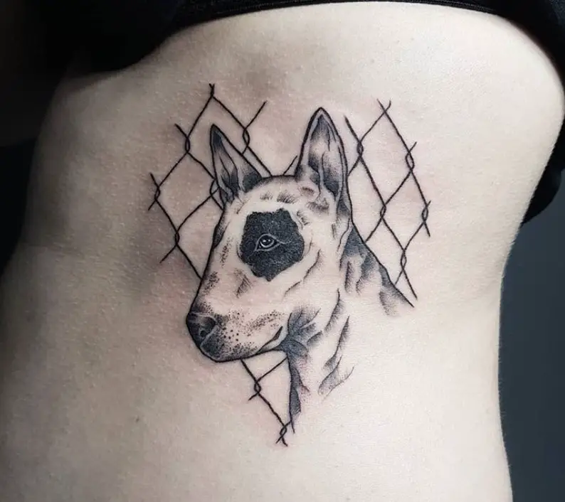 sideview face of a Bull Terrier in front of the fence tattoo on the side of the body