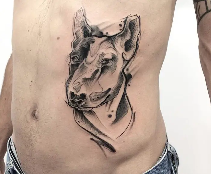 artistic black and gray face of a Bull Terrier tattoo on the side of the body.