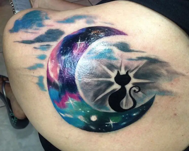 galaxy design crescent moon and a cat tattoo on the shoulder