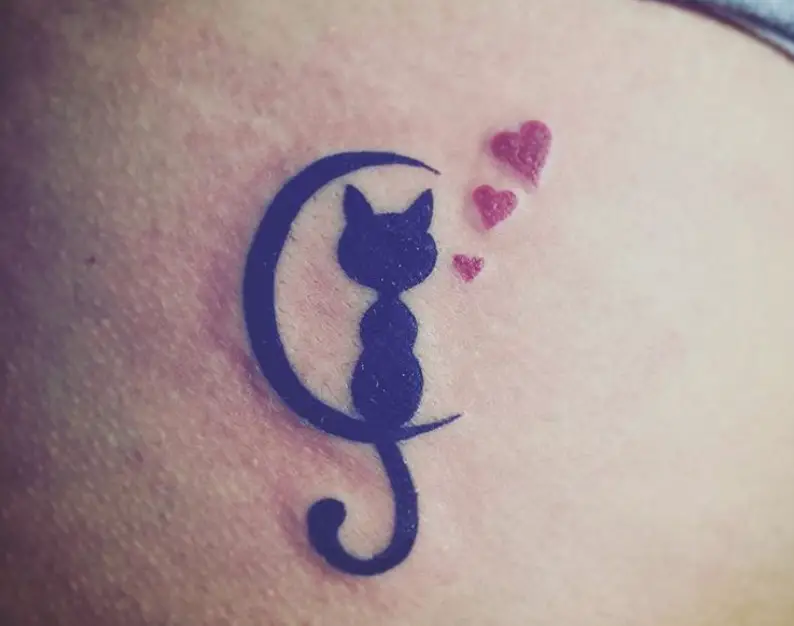 black cat on the crescent moon with red hearts tattoo