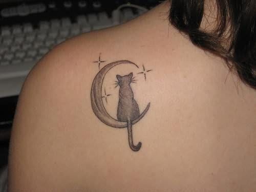 cat sitting on a crescent moon with stars tattoo on the back