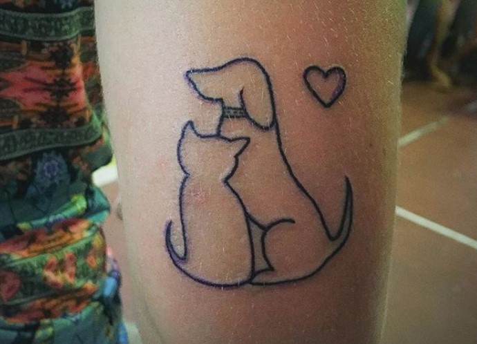 outline of dog and cat with heart beside tattoo on arms