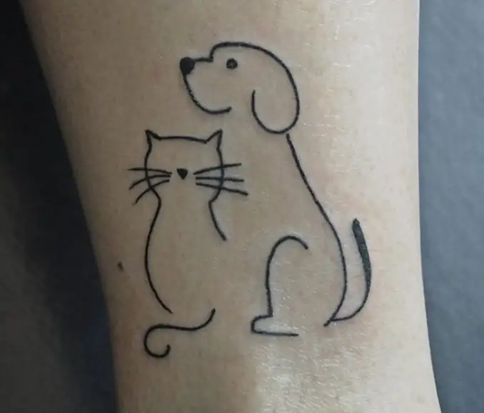 outline tattoo of dog and cat on the arm