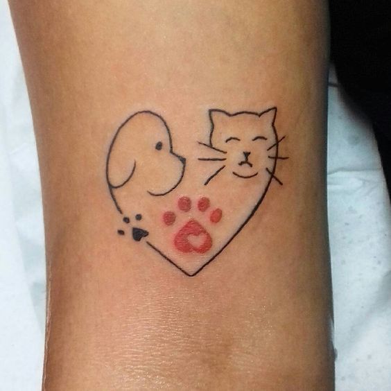 heart dog and cat with red paw in between them tattoo on the wrist