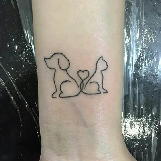 dog and cat facing on its opposite sides with its tails forming a heart together tattoo on the wrist