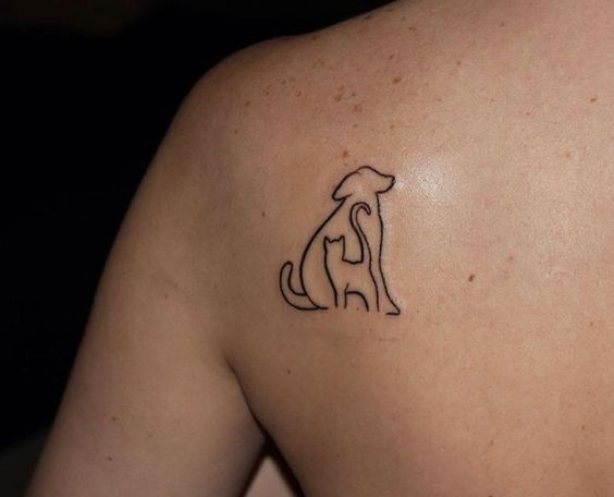 out line of sitting dog and standing cat tattoo on the back