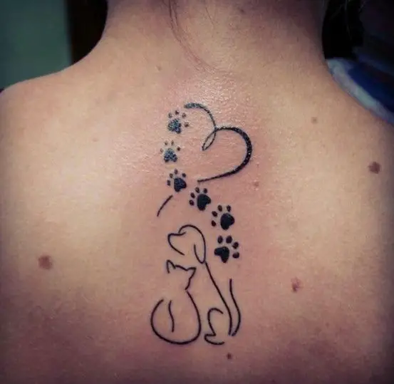 at & Dog with heart and paw on top of them tattoo on the back