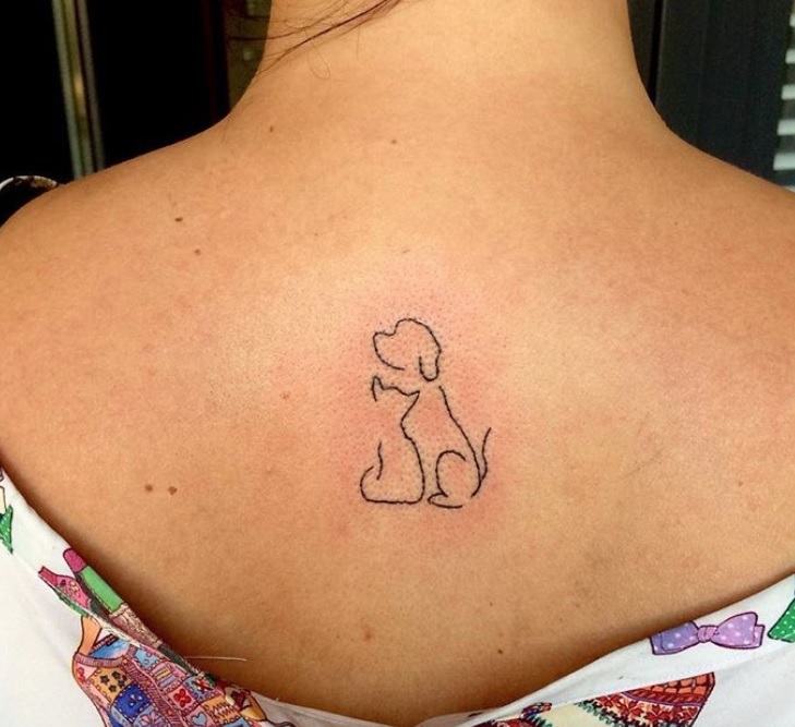 outline of sitting dog and cat tattoo on the back