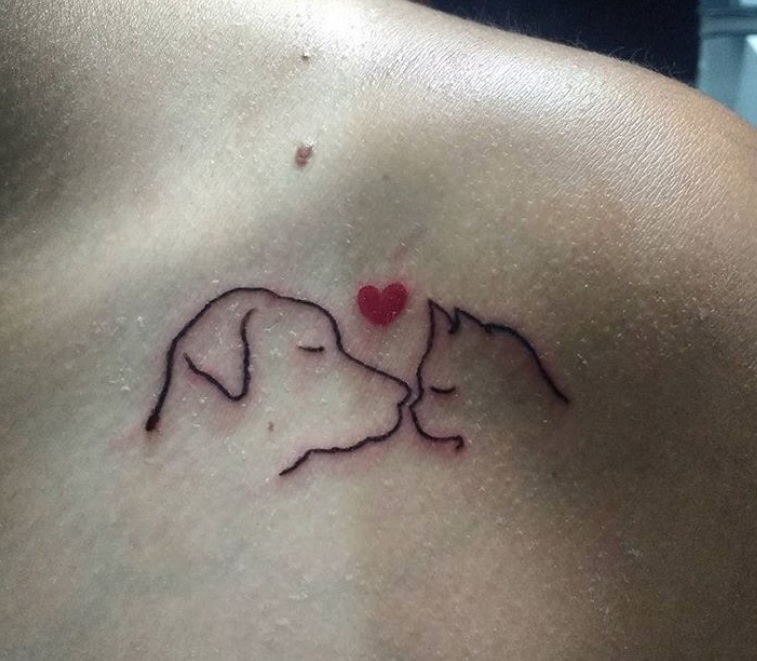 sideview faces of dog and cat with heart of top of them tattoo on the shoulders