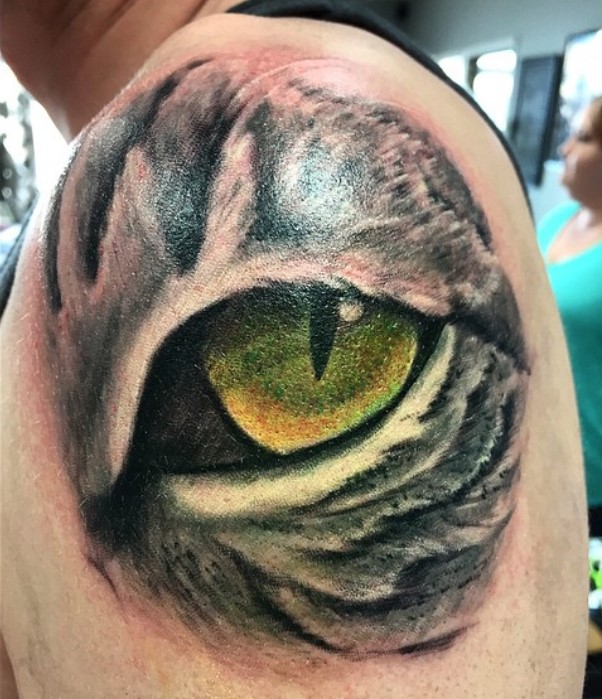 large Cat Eye tattoo on the shoulder