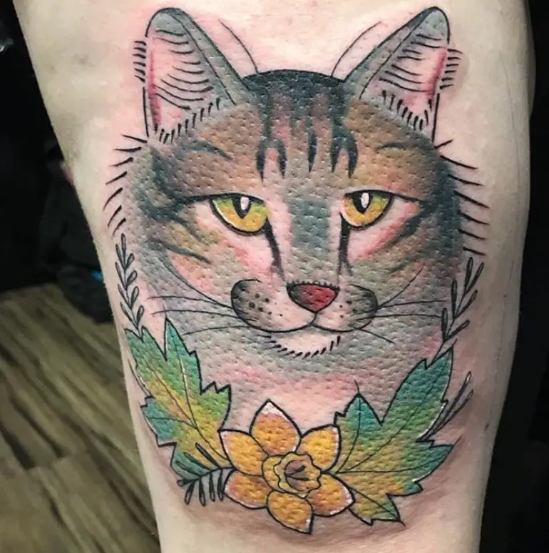 cat face with flowers tattoo on legs