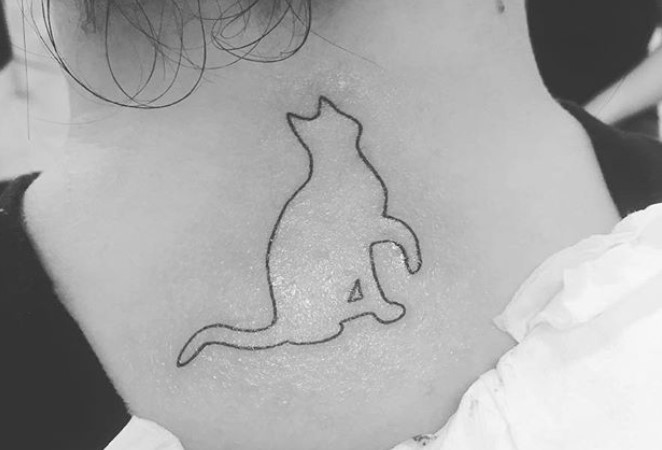 outline of a sitting cat tattoo on the neck