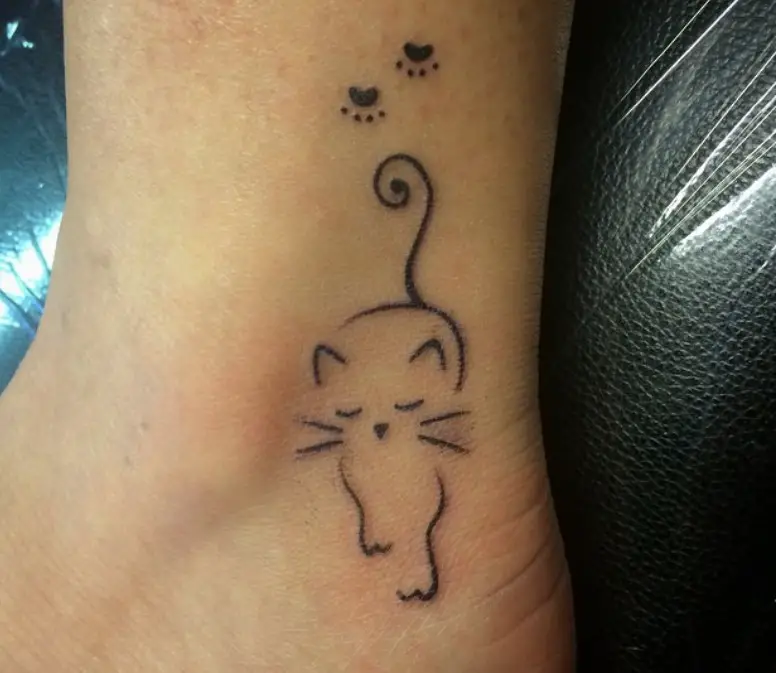 outline of a cat with paw prints tattoo on the ankle
