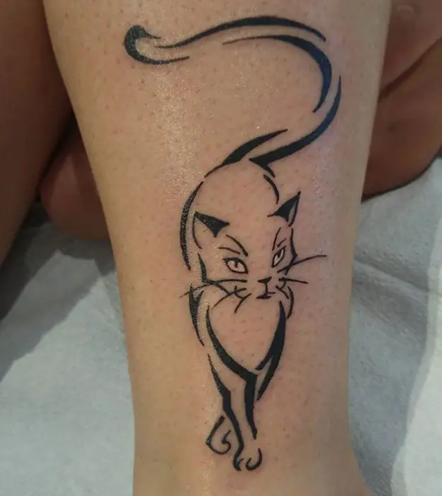 outline of a cat tattoo on the leg