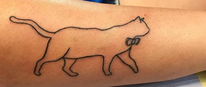 outline of a walking cat tattoo on the forearm