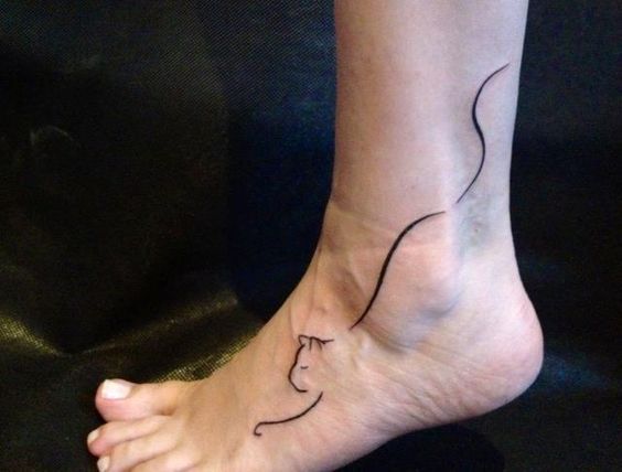 minimalist outline of a cat tattoo on the ankle