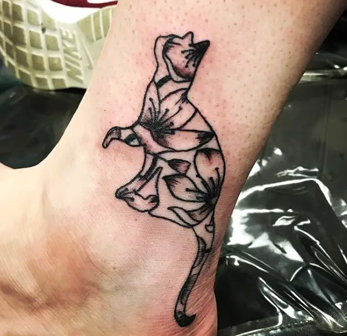 cat with flowers tattoo on the leg