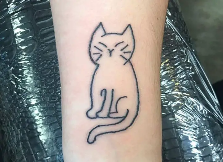 outline of a sitting cat tattoo on the leg