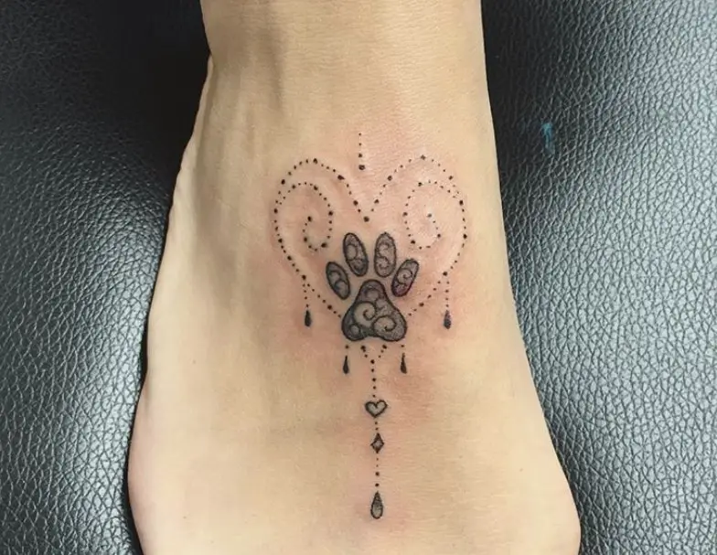 Cat Paw Print in mandala design inside a dotted heart shaped tattoo on feet