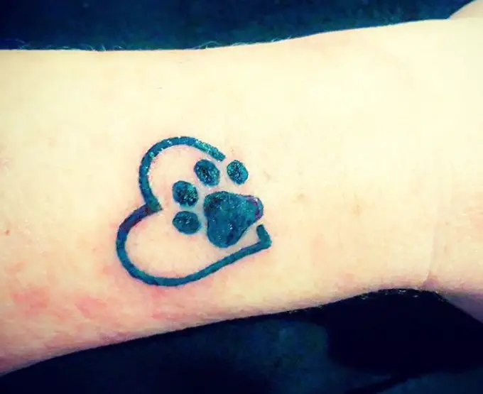 paw print in heart shape tattoo on the wrist