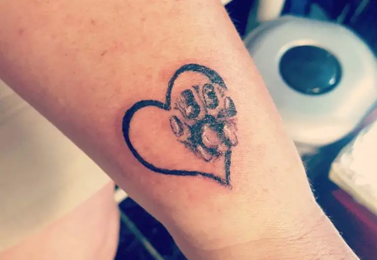 Cat Paw Print in a heart tattoo on the wrist