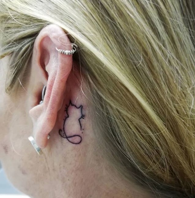 outline of Cat tattoo behind the ear of a girl