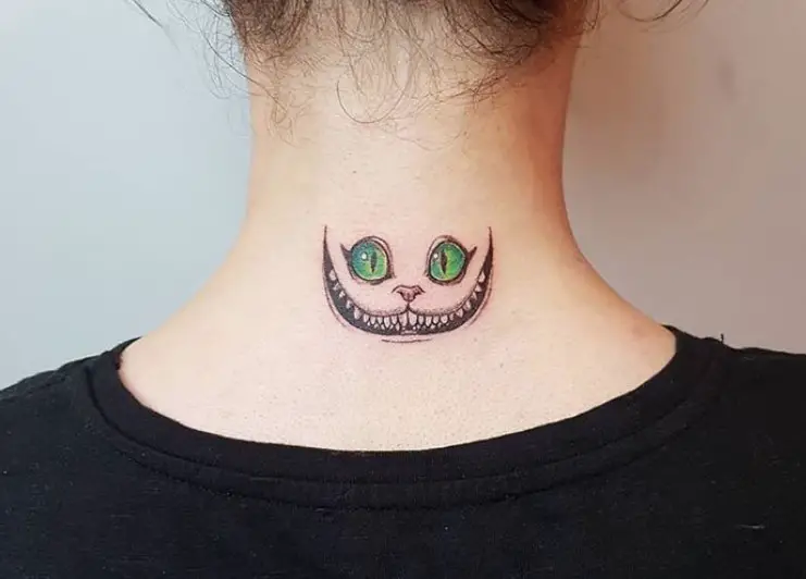 gray Cheshire Cat with pink nose and green eyes tattoo on the neck