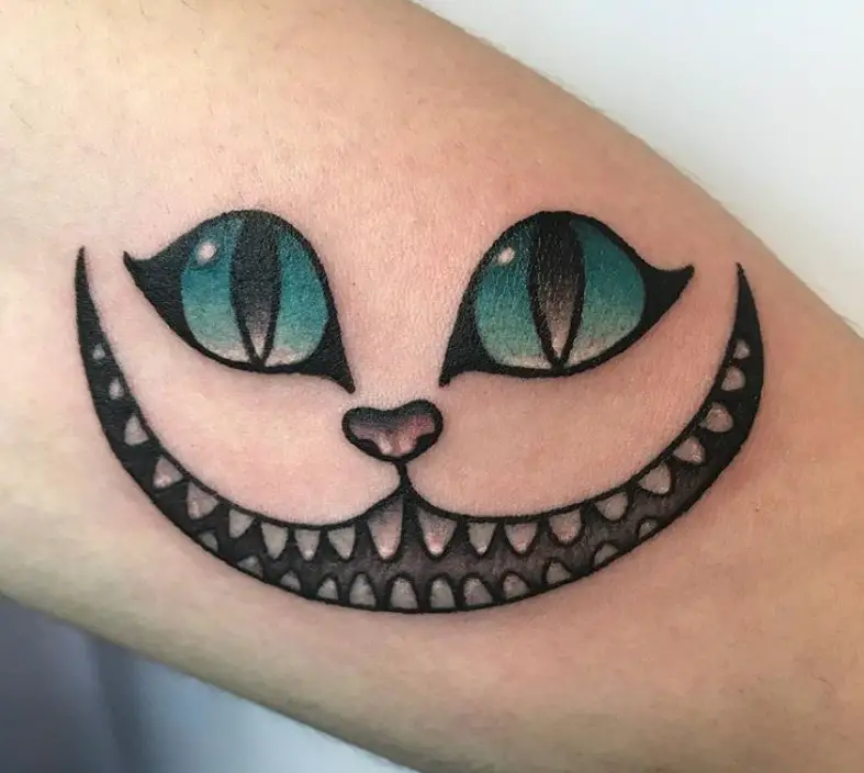 simple Cheshire Cat with bluegreen eyes tattoo