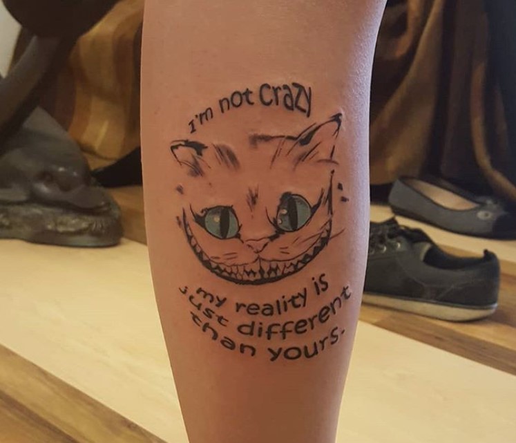 simple Cheshire Cat with blue eyes, and with words