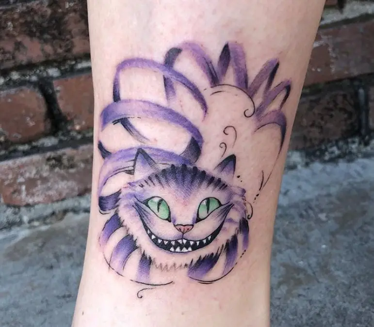 purple and black Cheshire Cat tattoo on the leg