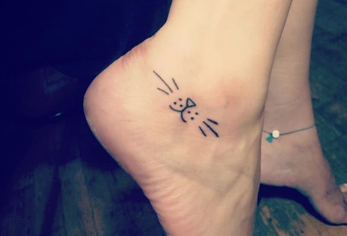 small mouth of a cat tattoo on the ankle