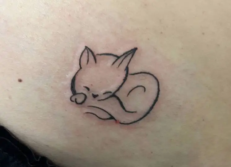 outline of a sleeping cat tattoo