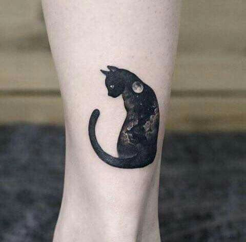 black cat designed with night time design tattoo on the leg