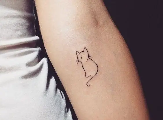 minimalist outline of a cat tattoo on the forearm