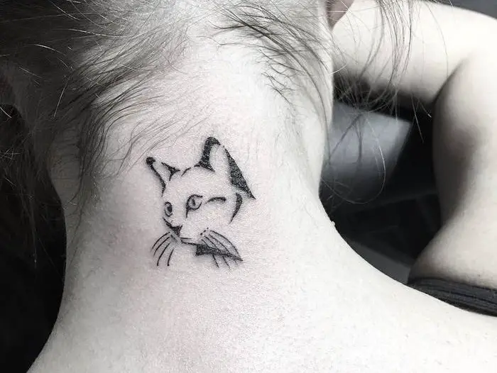 outline face of a cat tattoo on the back of the neck