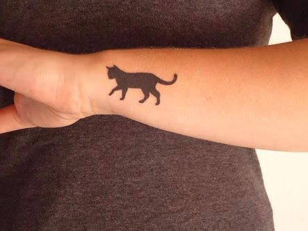 Black cat tattoo on the wrist