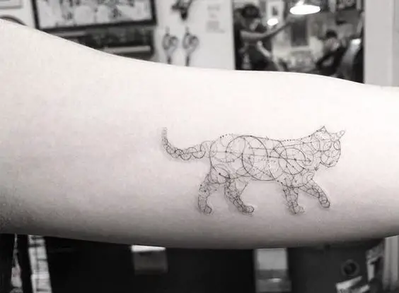 a cat with circle designs tattoo on the biceps