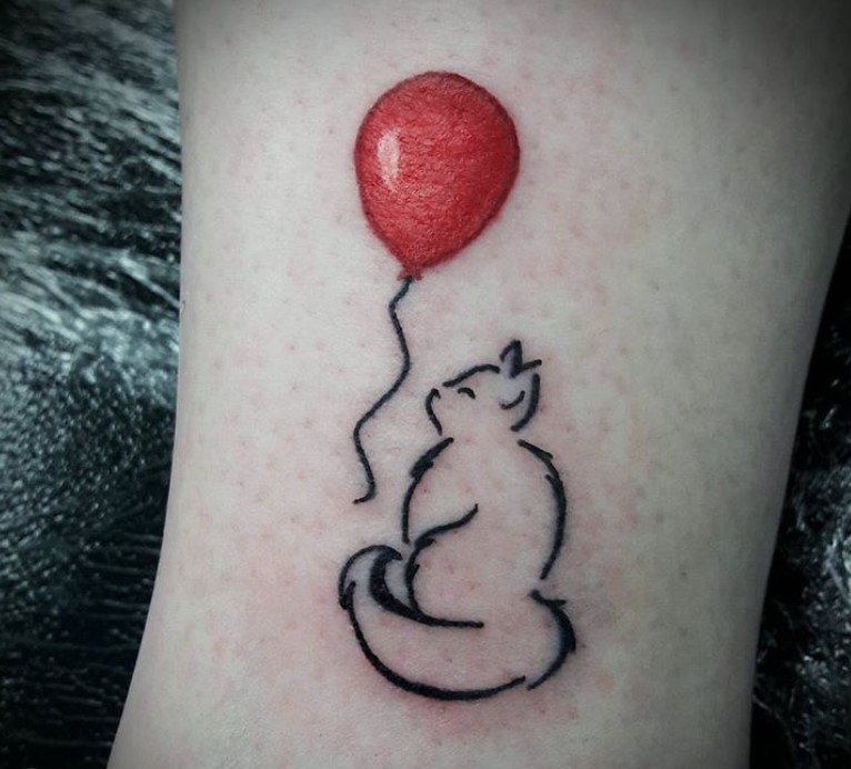 Outline of a cat with red balloon tattoo on the leg