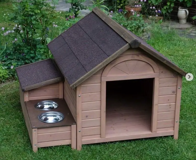 A brown modern wooden Dog House in the garden