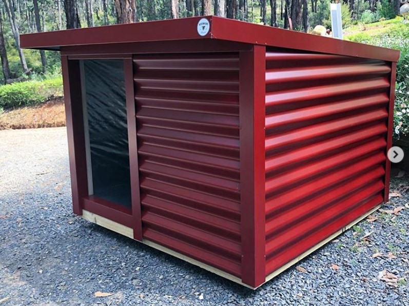 A dog house made of roof and steel